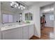 Bright bathroom with dual sinks, lots of counter space, vanity lighting, and access to the walk-in closet at 11117 Romola St, Las Vegas, NV 89141