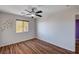 A bedroom with wood floors, white walls, and natural light coming through the window at 11117 Romola St, Las Vegas, NV 89141