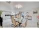 Contemporary dining room with a glass table, chandelier, and open-concept kitchen at 11117 Romola St, Las Vegas, NV 89141