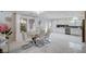 Bright dining room features a glass table, modern lighting, and sleek white tile flooring at 11117 Romola St, Las Vegas, NV 89141
