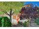 Well-maintained home featuring a two-car garage, complemented by lush trees and decorative holiday accents at 11117 Romola St, Las Vegas, NV 89141