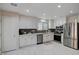Modern kitchen with white cabinetry, stainless steel appliances, and stylish backsplash at 11117 Romola St, Las Vegas, NV 89141