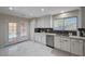 Bright kitchen with access to the pool, white cabinets, and stainless steel appliances at 11117 Romola St, Las Vegas, NV 89141