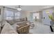 Bright living room with a large sectional sofa, white tile flooring, and modern light fixtures and holiday decorations at 11117 Romola St, Las Vegas, NV 89141