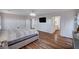 Spacious main bedroom featuring hardwood floors, a modern chandelier, and access to en-suite bathroom at 11117 Romola St, Las Vegas, NV 89141