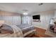 A large main bedroom with wood floors, a television, and three closets at 11117 Romola St, Las Vegas, NV 89141