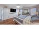 A spacious main bedroom with wood floors, a television, and a mirrored dresser at 11117 Romola St, Las Vegas, NV 89141