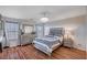 This main bedroom features wood flooring, a decorative light fixture, and neutral paint at 11117 Romola St, Las Vegas, NV 89141