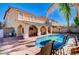 The backyard boasts a sparkling pool, covered patio, and ample seating for entertaining at 11117 Romola St, Las Vegas, NV 89141