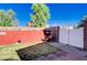View of backyard shed, and a gate leading to the side yard at 11117 Romola St, Las Vegas, NV 89141