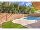 Backyard pool area featuring artificial turf, decorative gravel and a privacy wall at 1112 Caraway Ln, Las Vegas, NV 89144