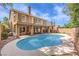 Backyard pool featuring a covered patio, second story balconies and desert landscaping at 1112 Caraway Ln, Las Vegas, NV 89144