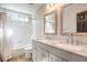Well-lit bathroom features a double sink vanity with marble countertop and a shower-tub combo at 1112 Caraway Ln, Las Vegas, NV 89144