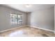 Bright and airy bedroom with neutral walls, tile flooring, and a large window offering backyard views, perfect for relaxation at 1112 Caraway Ln, Las Vegas, NV 89144