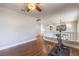 Bonus room with hardwood flooring and a ceiling fan next to landing overlooking the level below at 1112 Caraway Ln, Las Vegas, NV 89144