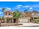 Charming two-story home featuring a neutral stucco finish, brick accents, a well-manicured front yard, and a two-car garage at 1112 Caraway Ln, Las Vegas, NV 89144