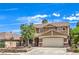 Charming two-story home featuring a neutral stucco finish, brick accents, a well-manicured front yard, and a two-car garage at 1112 Caraway Ln, Las Vegas, NV 89144