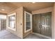 Inviting front porch featuring a double door entry, sidelight windows, neutral stucco finish, and modern recessed lighting at 1112 Caraway Ln, Las Vegas, NV 89144