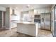 Modern kitchen featuring an island, stainless steel appliances, and white cabinetry at 1112 Caraway Ln, Las Vegas, NV 89144
