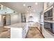 Modern kitchen featuring white cabinetry, stainless steel appliances, a large center island with countertop, and a stylish tile floor at 1112 Caraway Ln, Las Vegas, NV 89144