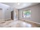 Inviting living room featuring tile flooring, neutral walls, large windows, and a front door, creating a comfortable living space at 1112 Caraway Ln, Las Vegas, NV 89144