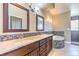 Modern main bathroom boasting dual sinks, a tiled backsplash, an oval soaking tub, and updated vanity at 1112 Caraway Ln, Las Vegas, NV 89144