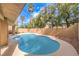 Sparkling pool surrounded by well-maintained landscaping offers a private backyard oasis at 1112 Caraway Ln, Las Vegas, NV 89144