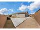 Large, private desert backyard with extended patio space surrounded by a brick wall at 1265 Inward Hill St, Henderson, NV 89002