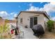 Private backyard with patio, lounge chairs, heat lamps, black BBQ grill, and desert landscaping at 1265 Inward Hill St, Henderson, NV 89002