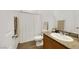 Modern bathroom features a wooden vanity with granite counters, a toilet, and a shower with white shower curtain at 1265 Inward Hill St, Henderson, NV 89002