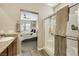 Bathroom with granite countertops, modern vanity, glass shower, and view into the adjacent bedroom at 1265 Inward Hill St, Henderson, NV 89002