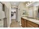 Bright bathroom featuring double sinks, granite counters, and a walk-in closet for ample storage at 1265 Inward Hill St, Henderson, NV 89002