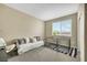 Bedroom with a white sofa, two dog kennels, and a window offering natural light at 1265 Inward Hill St, Henderson, NV 89002