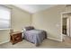 Bedroom with neutral walls and carpeting, featuring a window and a side table next to the bed at 1265 Inward Hill St, Henderson, NV 89002