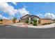 View of single-story home with two-car garage on corner lot with desert landscaping and brick wall at 1265 Inward Hill St, Henderson, NV 89002