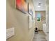 Neutral hallway with wall art leads to laundry with front load washer/dryer and grey vinyl floors at 1265 Inward Hill St, Henderson, NV 89002