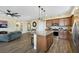 Open kitchen view featuring stainless appliances, granite island with pendant lighting, and adjacent living area at 1265 Inward Hill St, Henderson, NV 89002