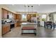 Bright kitchen boasting stainless steel appliances, a granite island, and seamless integration with the dining area at 1265 Inward Hill St, Henderson, NV 89002