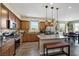 Spacious kitchen with stainless appliances, granite counters, an island, and an adjacent dining area at 1265 Inward Hill St, Henderson, NV 89002
