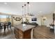 Open-concept living room showcasing modern decor, stylish lighting, and seamless flow from kitchen to dining area at 1265 Inward Hill St, Henderson, NV 89002