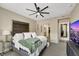 Inviting main bedroom with walk-in closet access, plush carpeting, and modern ceiling fan at 1265 Inward Hill St, Henderson, NV 89002
