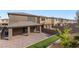 Backyard featuring covered patio, brick pavers, and landscaped area at 127 Medianoche St, Las Vegas, NV 89138