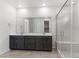 Bathroom with double vanity, large mirror, and glass enclosed shower with bench at 127 Medianoche St, Las Vegas, NV 89138