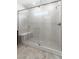 Modern bathroom featuring glass shower with a bench and tiled surround at 127 Medianoche St, Las Vegas, NV 89138