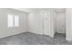 Bedroom with shuttered window, grey floors, white trim, and white doors at 127 Medianoche St, Las Vegas, NV 89138