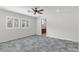Bedroom featuring grey floors, ceiling fan, and shuttered windows at 127 Medianoche St, Las Vegas, NV 89138