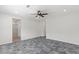 Bedroom with grey floors, ceiling fan, and bathroom access at 127 Medianoche St, Las Vegas, NV 89138