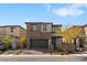 Beautiful two-story home featuring a gray exterior, two-car garage, and landscaped front yard at 127 Medianoche St, Las Vegas, NV 89138