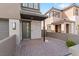Inviting front entrance with a stone facade and a brick paved driveway at 127 Medianoche St, Las Vegas, NV 89138