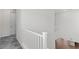 Hallway with white railings, grey floors, and white doors and trim at 127 Medianoche St, Las Vegas, NV 89138